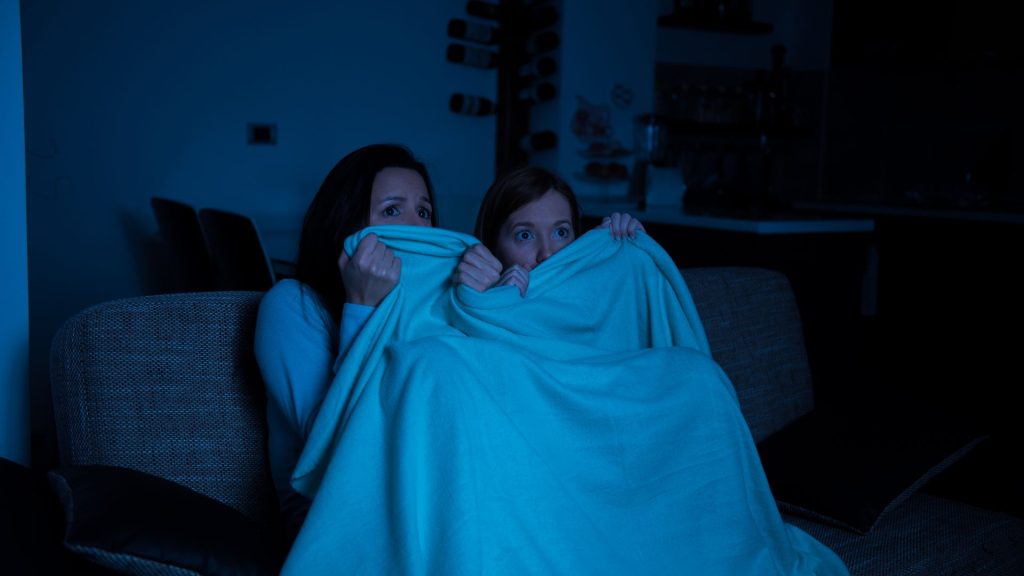 scared people under blanket