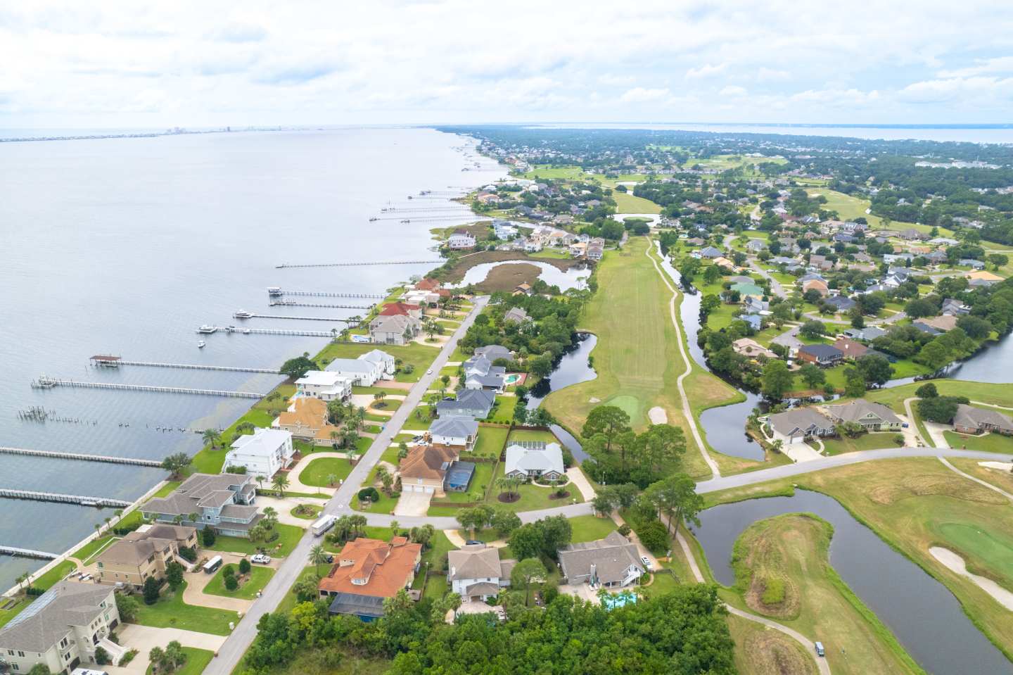 Aerial view of Gulf Breeze, FL waterfront homes and coastal community.