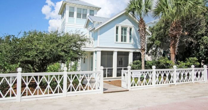 Coastal home with a metal roof and impact windows built for hurricane resilience