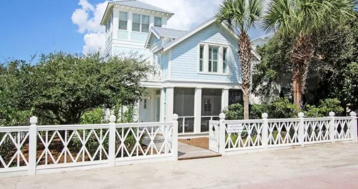 Coastal home with a metal roof and impact windows built for hurricane resilience
