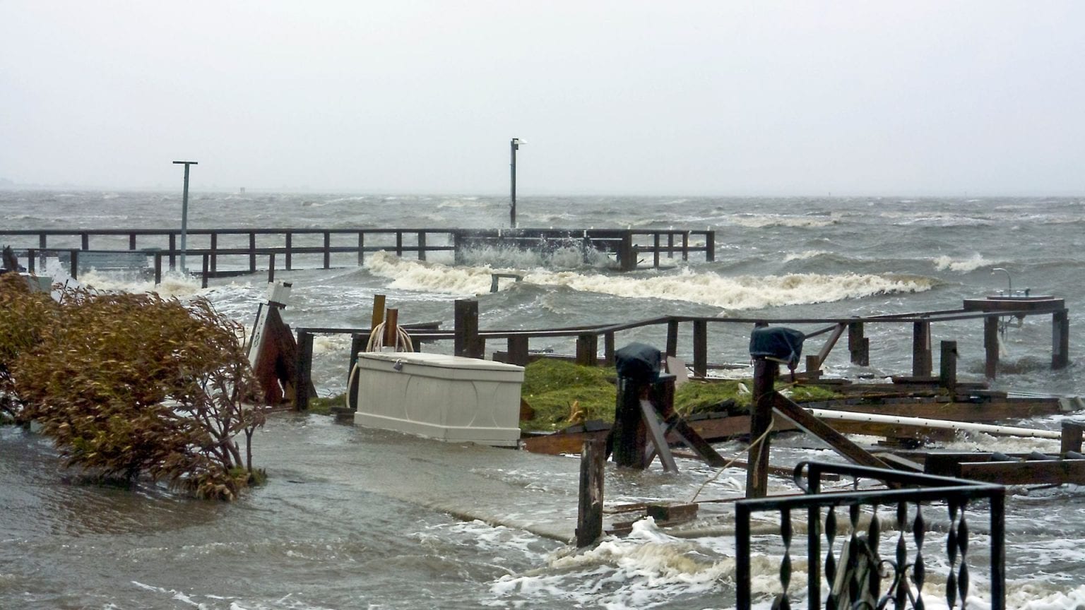 Standing floodwater near a Gulf Coast beach house illustrating flood zone risk
