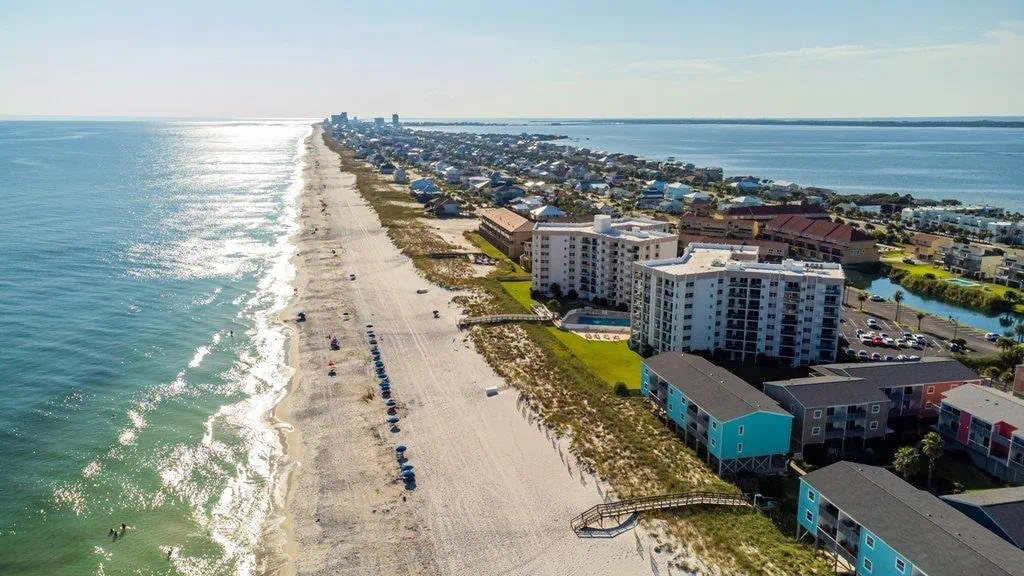 Aerial view of Pensacola beach and Gulf Coast community, Florida real estate opportunities.