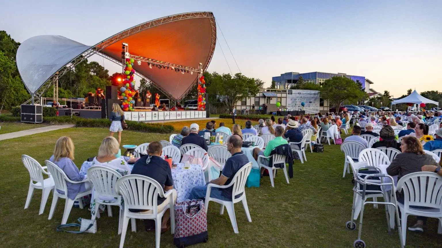 Casino Beach Gulfside Pavilion concert series with lawn chairs and waterfront views.